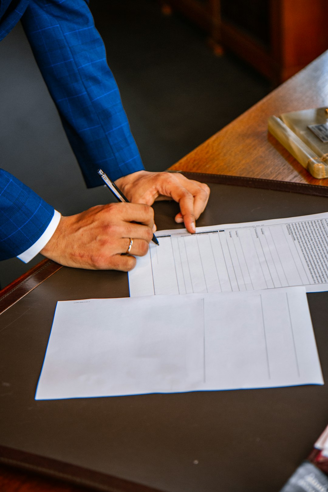 Person filling out a form on paper at a desk — representing the manual evidence collection process